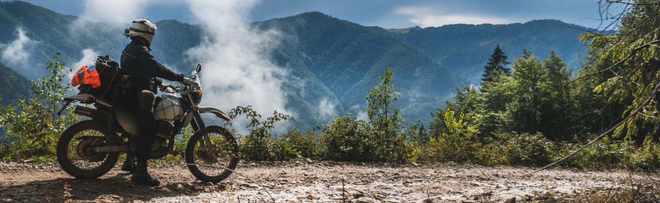 man overlooking the mountains on trail ride off road