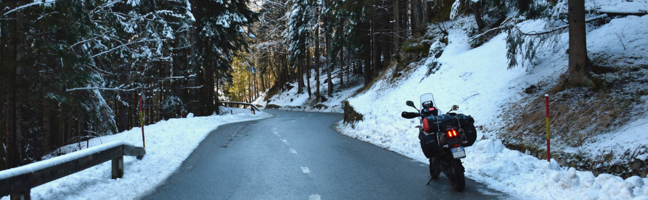 Motorcycle parked on snowy road